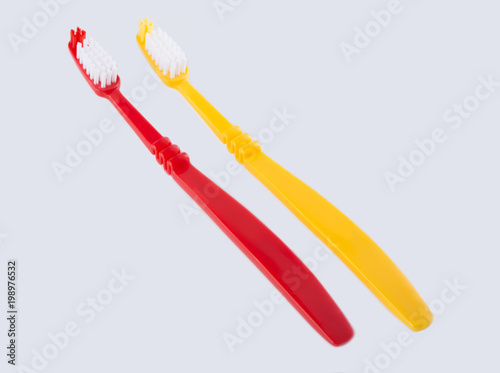 Red toothbrush isolated on white background. Means of personal hygiene.