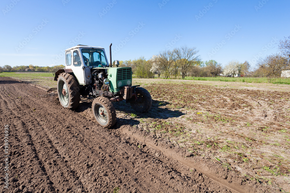Obraz premium The tractor plows the earth