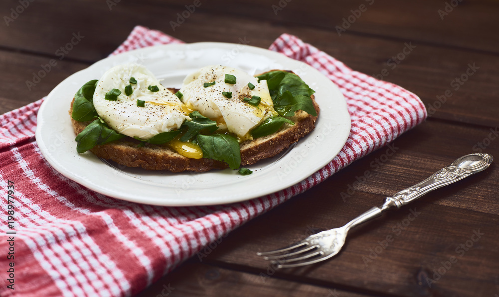 Tasty poached egg on toast over rustic background Tasty poached egg on toast over rustic background