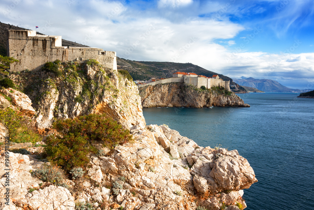 View of the fortress of St. Lawrence and the fortress wall around the Old City in Dubrovnik on a sunny day