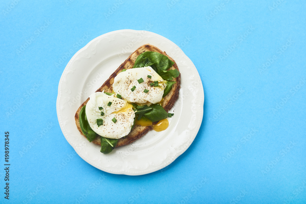 Tasty poached egg on toast over rustic background Tasty poached egg on toast over rustic background
