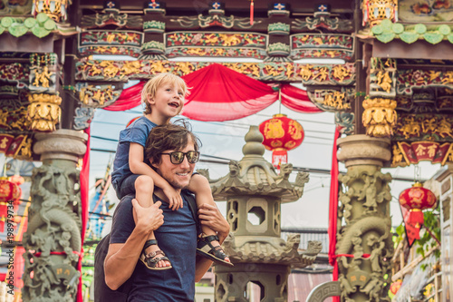 Dad and son are tourists on the Street in the Portugese style Romani in Phuket Town. Also called Chinatown or the old town