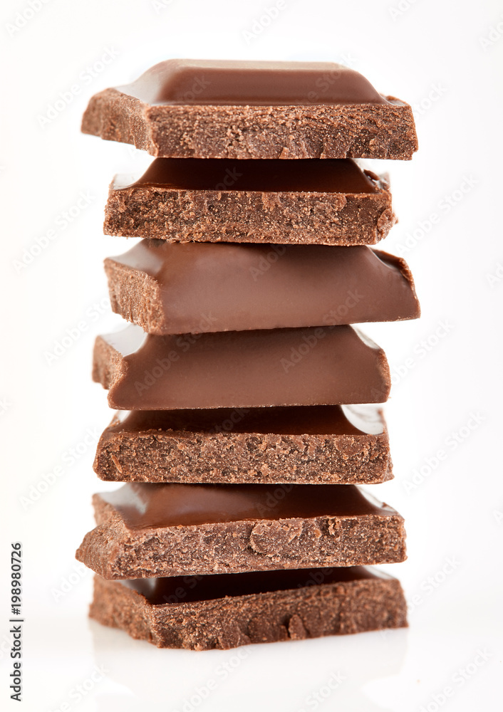 Milk chocolate pieces isolated on white background. Milk chocolate pieces isolated on white background.