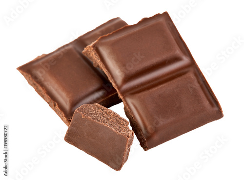 Milk chocolate pieces isolated on white background.