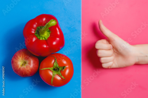 Close up Picture of Fresh Red Apple, Pepper, Tomato and Woman Showing Thumbs up. Healthy Food Concept. photo