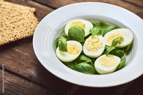 tasty boiled eggs over rustic background