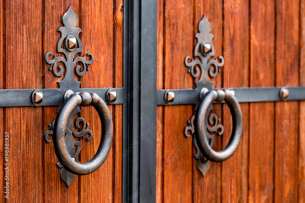 wooden gate with wrought iron elements close up wooden gate with wrought iron elements close up