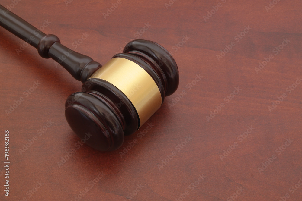 Wooden judge gavel on brown wooden table with space for text Wooden judge gavel on brown wooden table with space for text