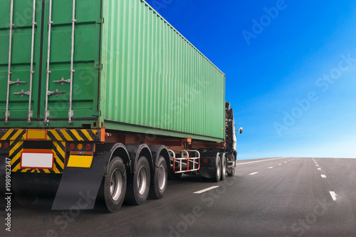 Truck on highway road with green container, transportation concept.,import,export logistic industrial Transporting Land transport on the asphalt expressway.with blue sky background