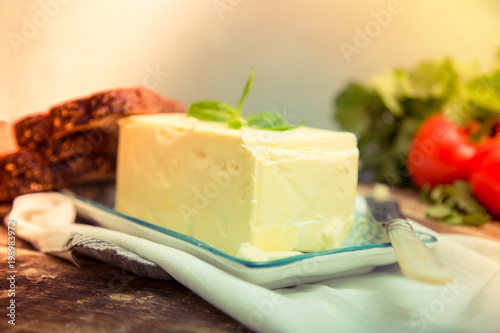 Natural organic fresh ingredients for any food cooking as butter, tomatoes, green coriander on wooden background