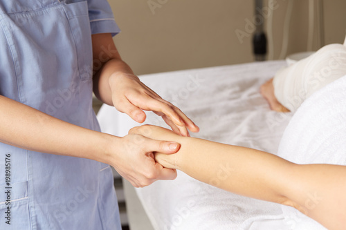 woman's hand massage in spa club