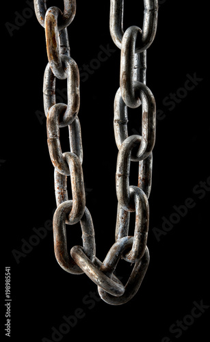 Close up old rusty chain isolated on black background.