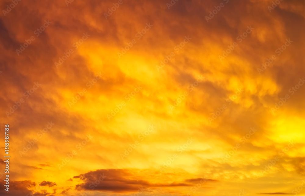Beautiful fiery sunset sky. Cloudy abstract background.