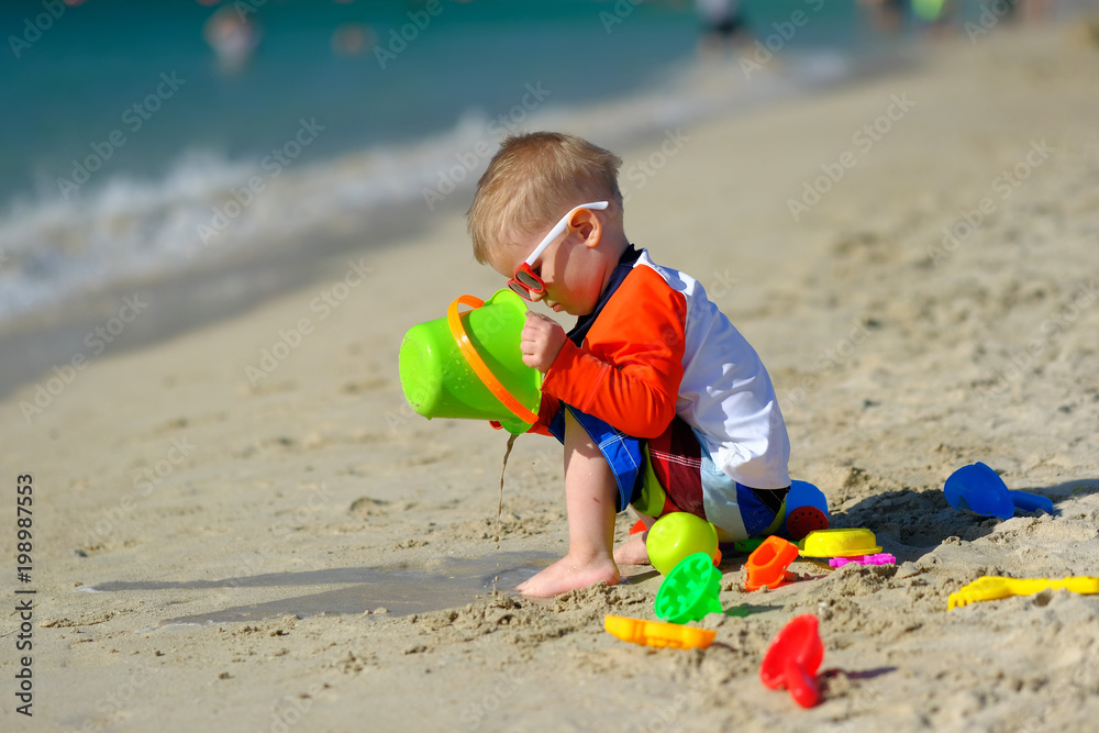 Two year old toddler playing on beach Two year old toddler playing on beach