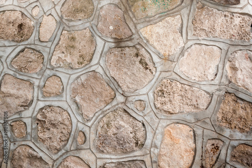Background of natural porous stones of arbitrary shape  fastened together with a cement screed.