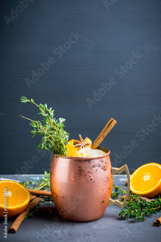 Photography Cold orange Moscow mule cocktail in copper mug. Selective focus.