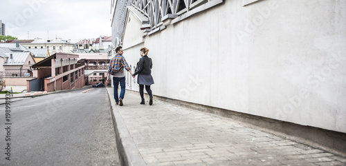 photographer takes photos of a couple in love walking down the street