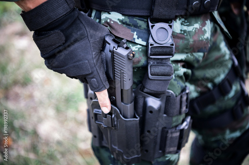 Closeup swat soldier with gun. Specail forces holding a gun concept.