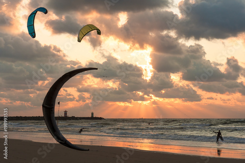 Kite surfing in the sunset at the beach of Scheveningen, the Netherlands