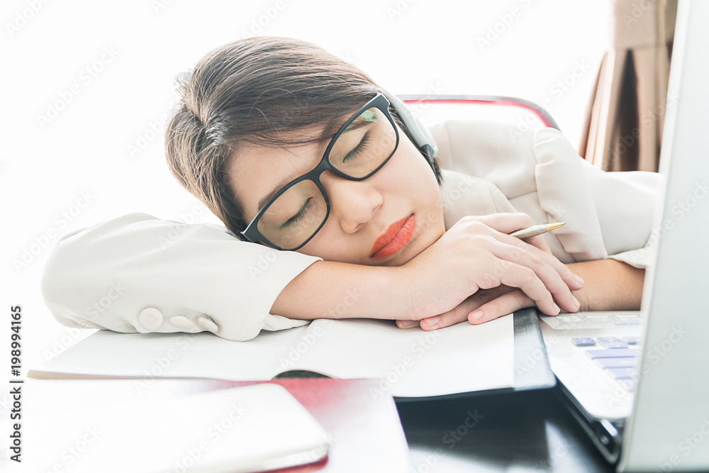 Teenage girl short hair sleep on desk after working Teenage girl short hair sleep on desk after working
