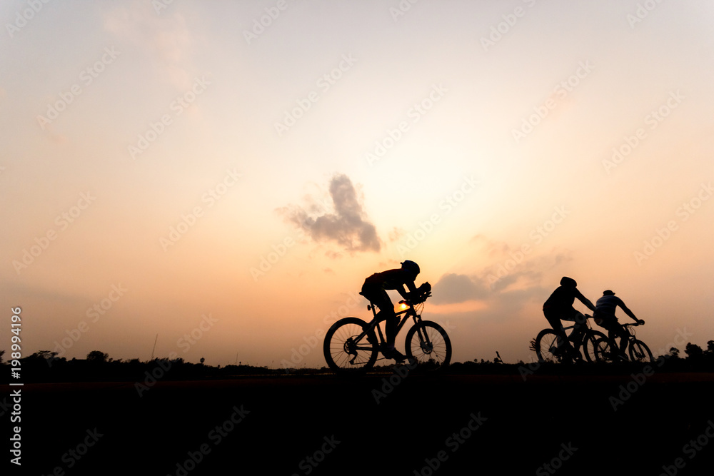 Obraz premium Silhouette of cyclist on beautiful sky ,Man ride bicycle on sunset background