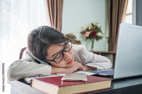 Teenage girl short hair sleep on desk after working