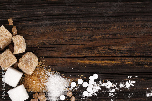 Various types of sugar from above on wooden table
