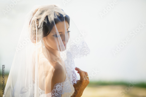 Obraz na plátně portrait of the beautiful bride close-up covered with a veil
