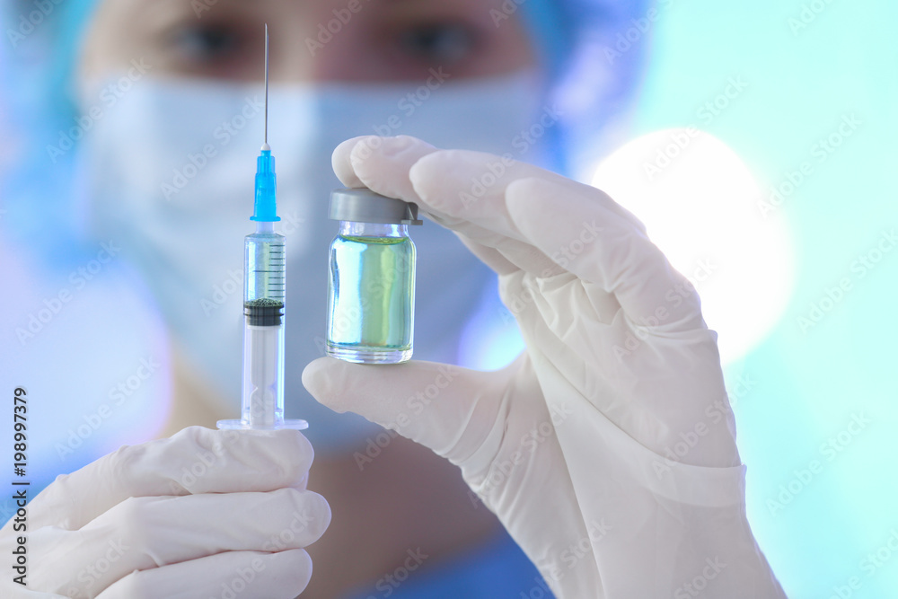 Fototapeta premium Doctor holding syringe and medicine for vaccination, closeup