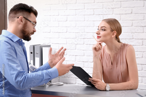 Male receptionist with trai...