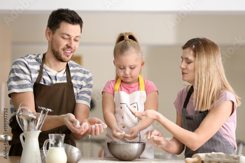 Happy family with flour in ...