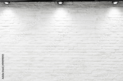 Empty white wall with halogen with lamps.