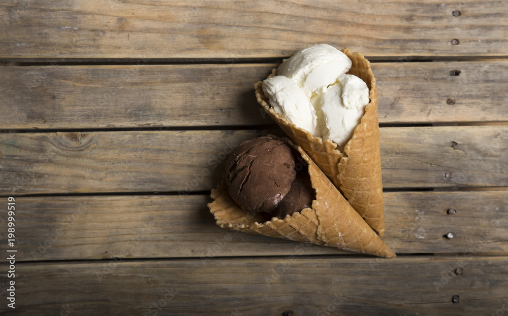 Variety of ice cream scoops in cones with chocolate, vanilla and strawberry Variety of ice cream scoops in cones with chocolate, vanilla and strawberry