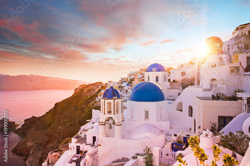 Sunset view of the blue dome churches of Santorini, Greece.