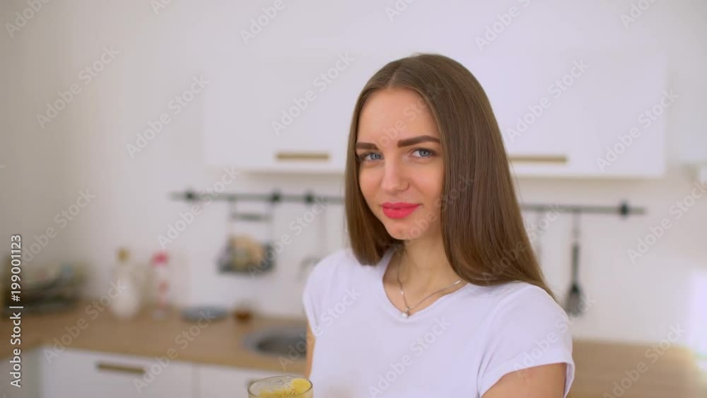 Apple juice - woman juicing apples and vegetables and drinking it fresh at home in kitchen giving thumbs up. Juice machine and healthy eating happy woman making green vegetable and fruit juice. 4 k Apple juice - woman juicing apples and vegetables and drinking it fresh at home in kitchen giving thumbs up. Juice machine and healthy eating happy woman making green vegetable and fruit juice. 4 k