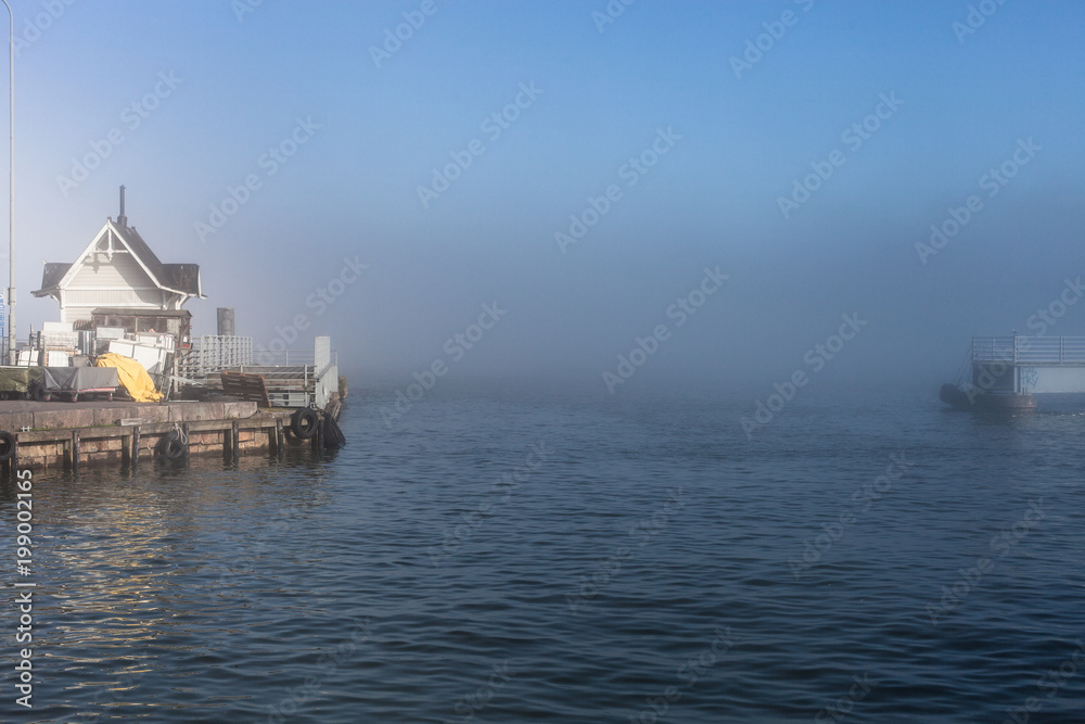 Winter in Finland: sea mist over a dock in the cold Helsinki