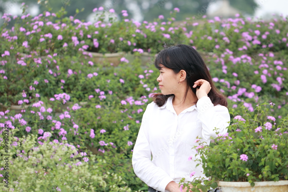 woman at the flower garden in Hanoi, Vietnam woman at the flower garden in Hanoi, Vietnam
