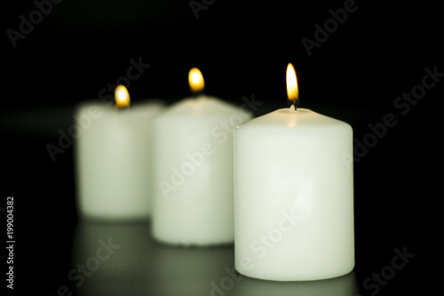 Candle on isolated black background.