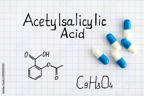 Chemical formula of Acetylsalicylic Acid with some pills. photo