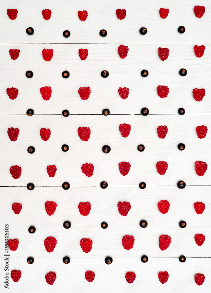 Rows of ripe sweet raspberries and black currant, free space. Fresh berries on white wooden background. Summer, healthy food concept. Berries background Rows of ripe sweet raspberries and black currant, free space. Fresh berries on white wooden background. Summer, healthy food concept. Berries background