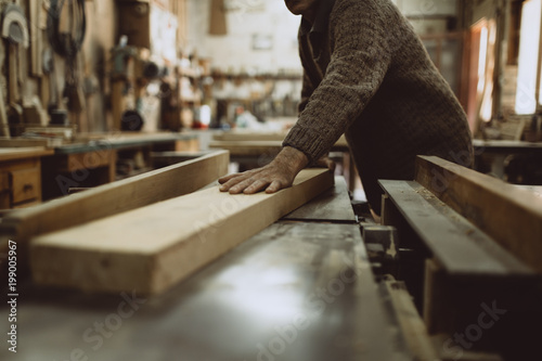 Close up shot of old master carpenter working in his woodwork or workshop © Dusko