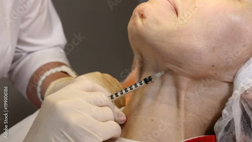 Beauty clinic. Beautician hands in gloves making face anti-aging injection in a female neck. A woman gets beauty facial cosmetology procedure. Botox. collagen injections photo