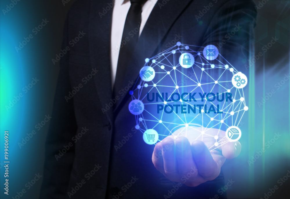 Business, Technology, Internet and network concept. Young businessman working on a virtual screen of the future and sees the inscription: Unlock your potential Business, Technology, Internet and network concept. Young businessman working on a virtual screen of the future and sees the inscription: Unlock your potential