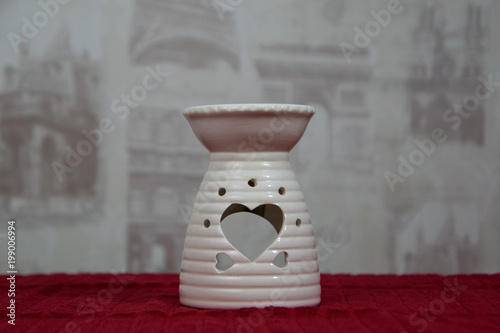 White ceramic candle light holder, with the heart shape on it photo