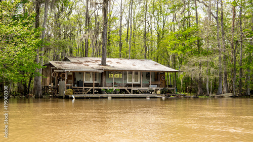 A cajun fish camp in the swamp is gradually being flooded and taken back by the rising waters. photo