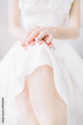 Young bride hands and legs. Festive wedding fashion minimal concept.