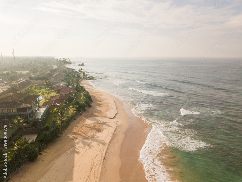 Resort on the coast of the ocean. Aerial view. Beautiful ocean coast in the sunlight, aerial view. Drone photography