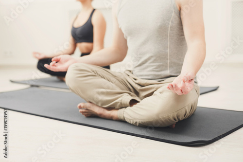 Young couple meditating together in studio