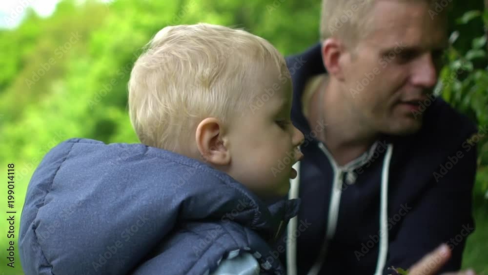 Father and son playing together in park Father and son playing together in park