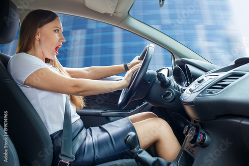 Young frightened driver woman squealing brakes avoiding an accident photo